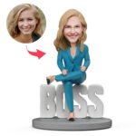 Close-up of custom female boss bobblehead with personalised name engraving